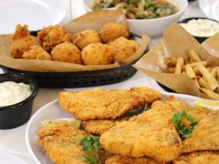Family style meals feeds a family of four at Sea Island Shrimp House including fried fish, fried shrimp and lemon pepper fish