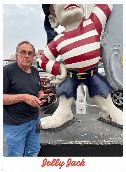 man with jolly jack statue in front of Sea Island
