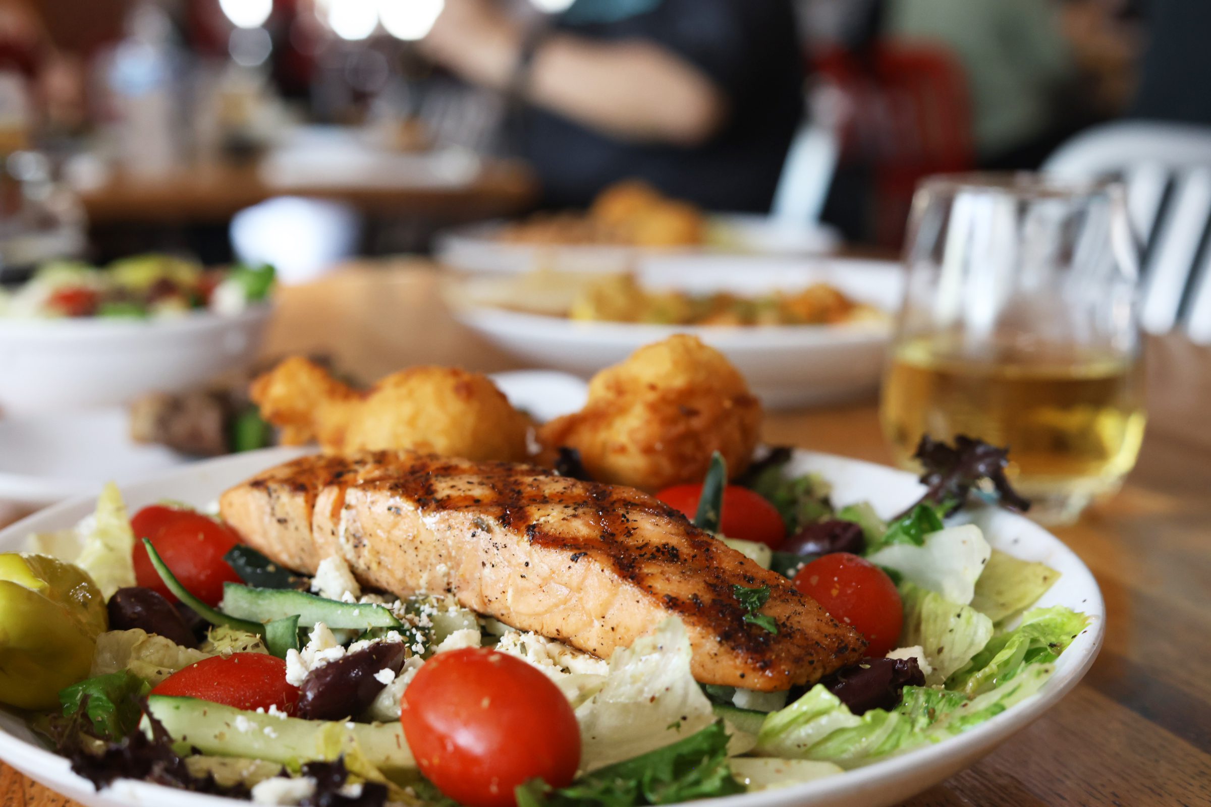 Grilled Salmon Salad and glass of Chardonnay- Wine pairings with seafood