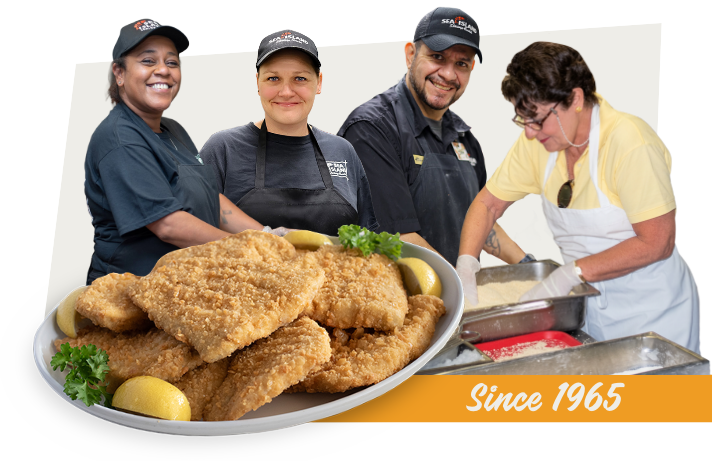 Sea Island Shrimp House team members preparing hand-breaded fish, since 1965